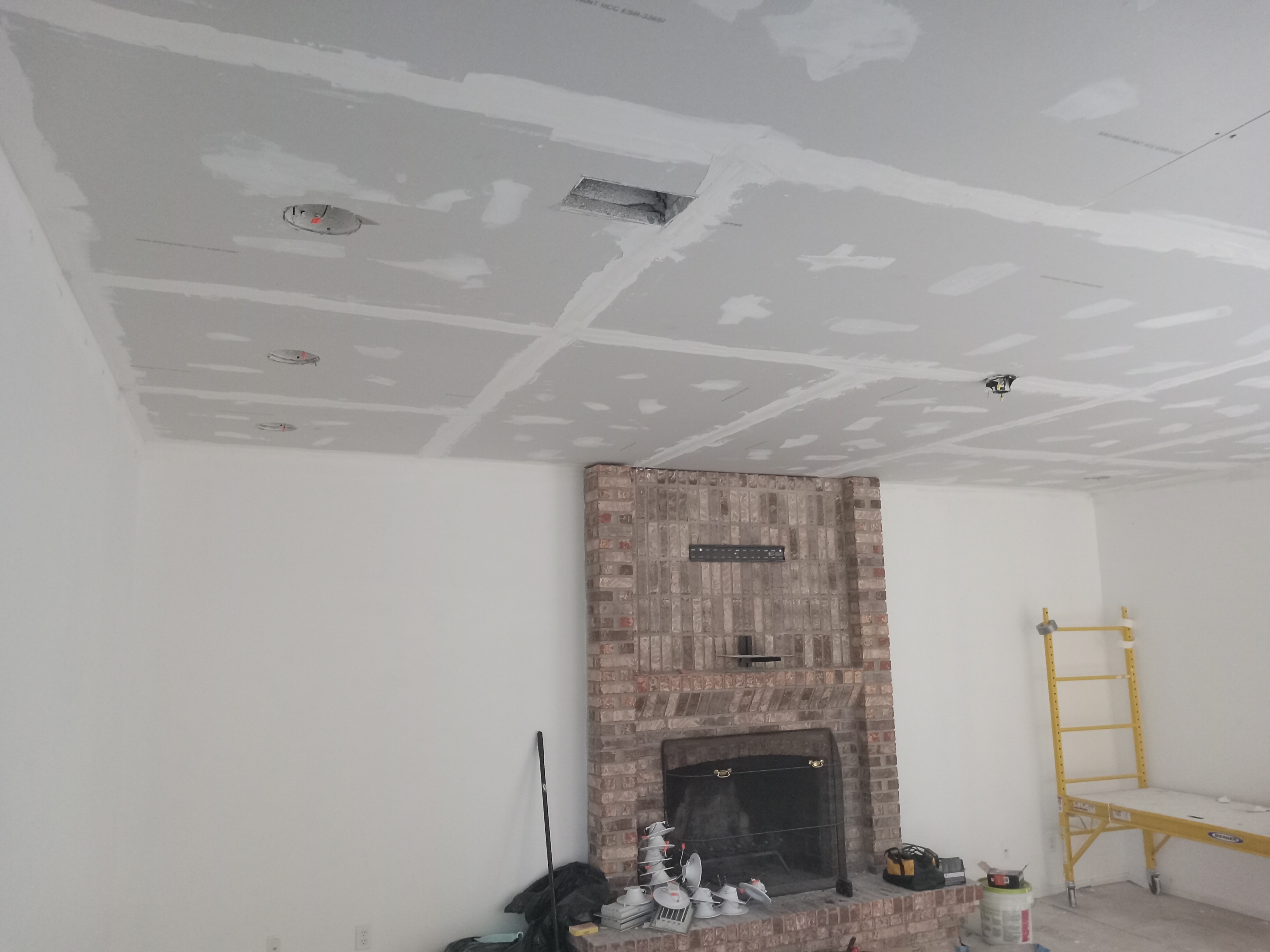 Ceiling before repair — visible drywall patches and joints
