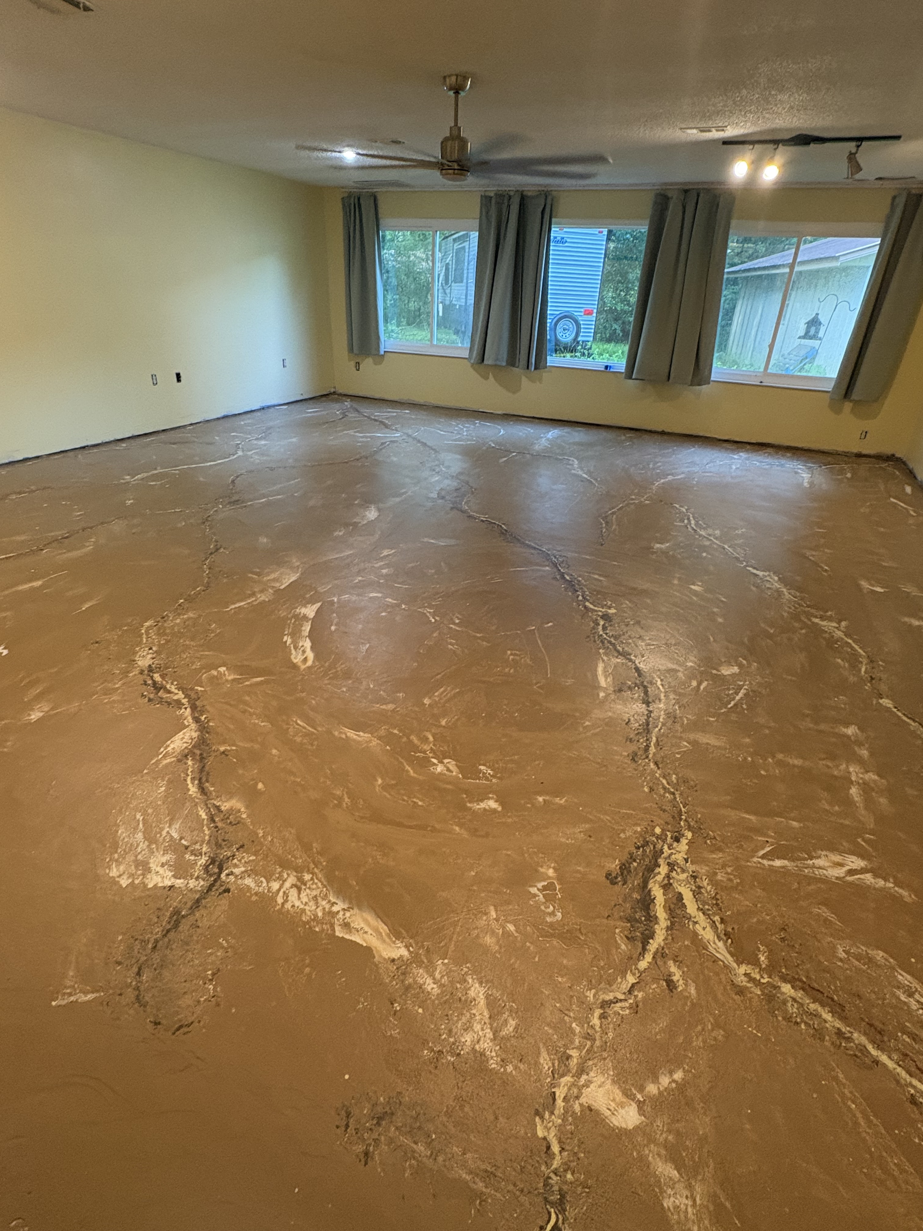 Living room concrete floor with glossy epoxy topcoat, finished