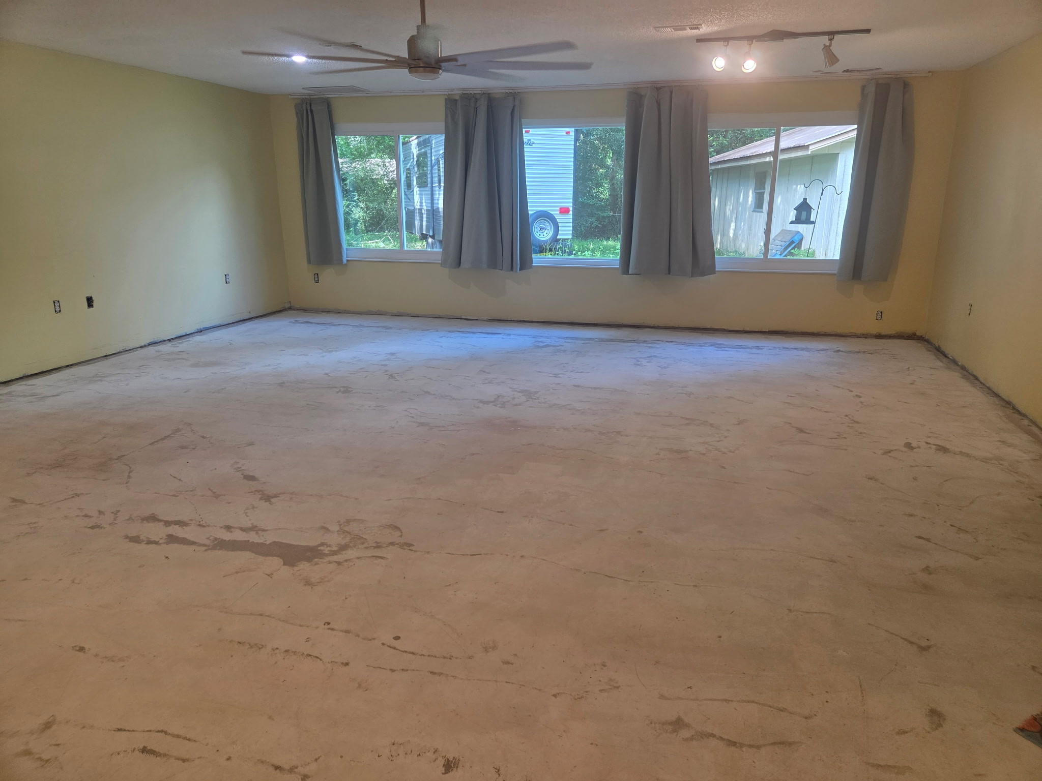 Living room bare concrete floor before epoxy coating