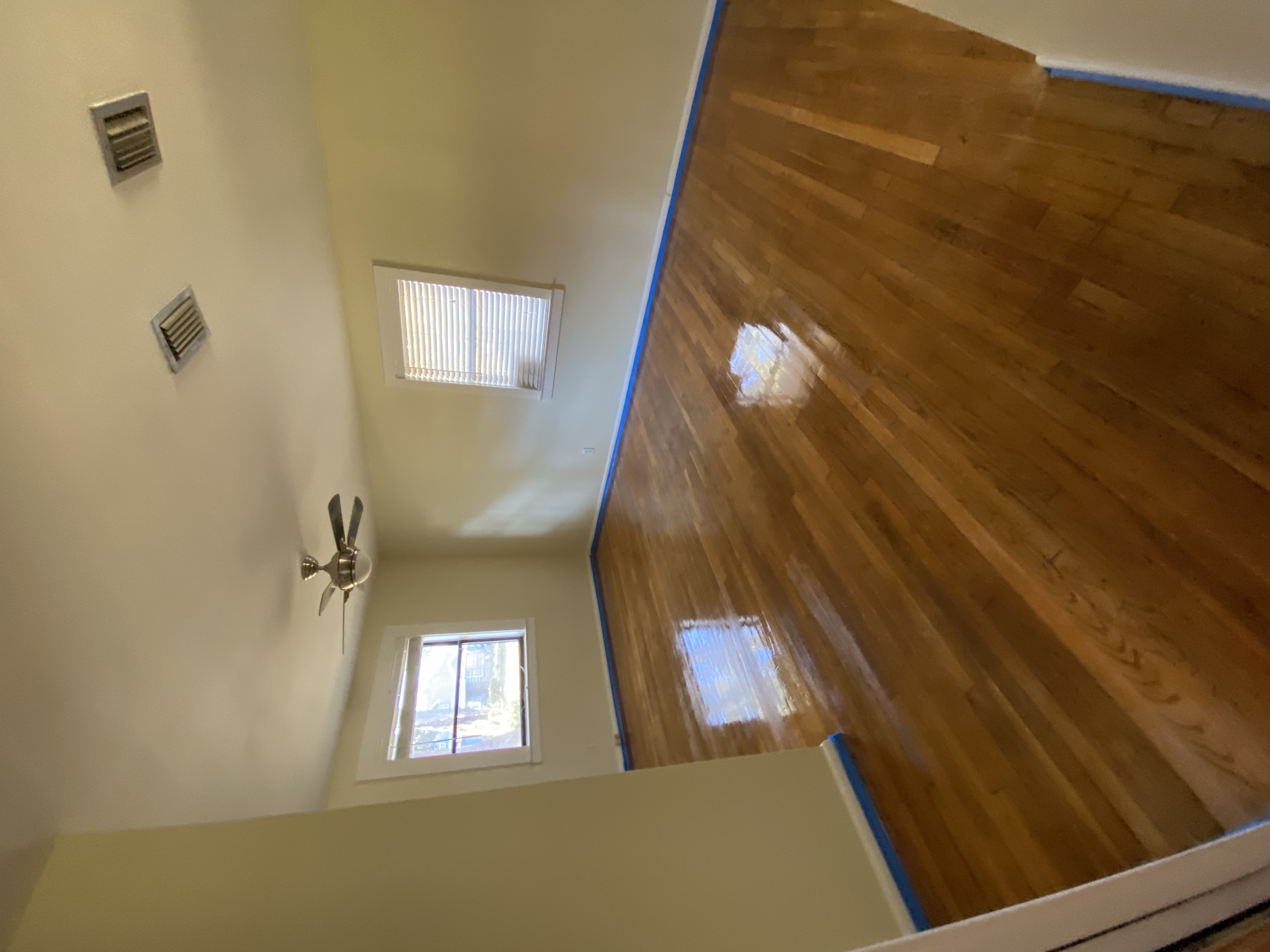 Refinished hardwood floor — glossy, freshly sealed